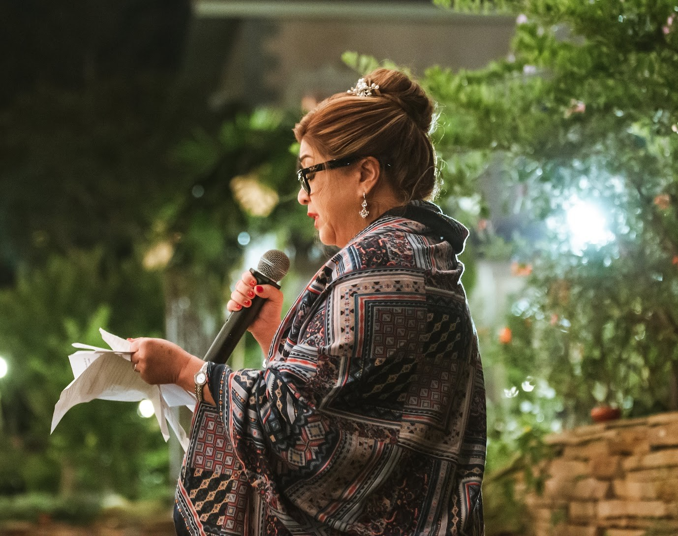 Coach Amy Soukchaleun speaking at a community gathering.