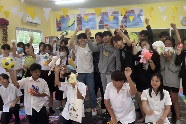 High school students in Thailand celebrating at a classroom event.